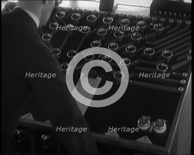 A Male Civilian Using System of Levers and Cogs To Make the Automated Railway Marshalling..., 1931. Creator: British Pathe Ltd.