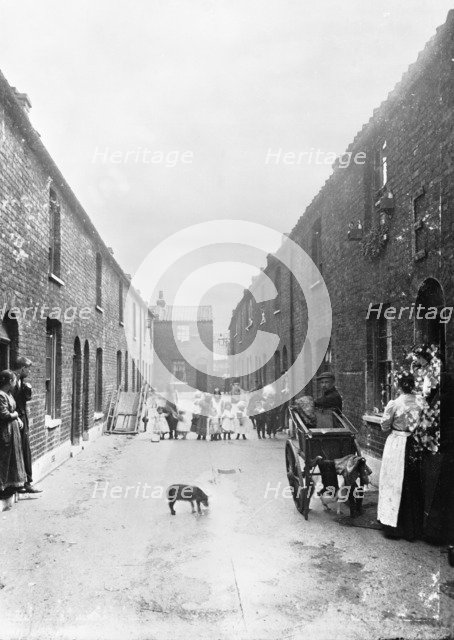 Cat's meat man on a slum street, London, 1900s. Artist: John Galt