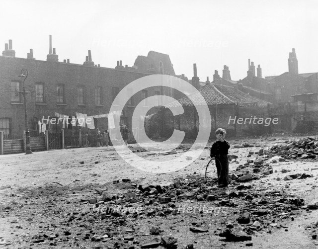 Boy playing on sewage works, East End, London, c1951. Artist: Henry Grant