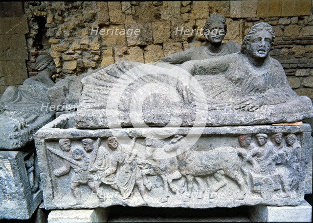 Etruscan stone sarcophagus with reliefs of Eastern influence, with a sculpture of a woman lying o…