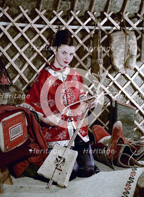 Model showing an evening jacket in oriental style, 1950s.  Artist: Göran Algård