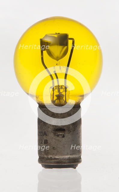 Yellow headlamp bulb. Creator: Unknown.