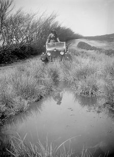 Kitty Brunell road testing a Riley 9 WD tourer, c1930. Artist: Bill Brunell.