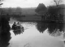 Austin Ulster driving through a ford during a motoring trial, 1936. Artist: Bill Brunell.