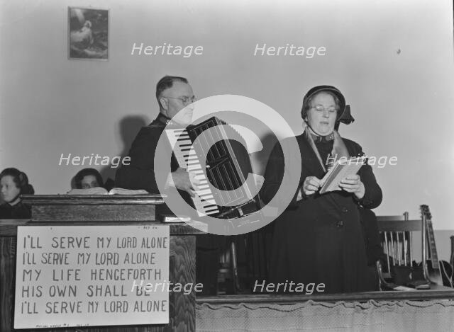 Adjutant and his wife sing, Salvation Army, San Francisco, California, 1939. Creator: Dorothea Lange.