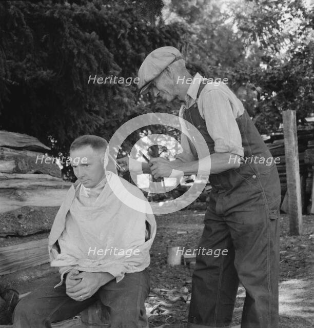 Bean pickers barber each other, near West Stayton, Marion County, Oregon, 1939. Creator: Dorothea Lange.