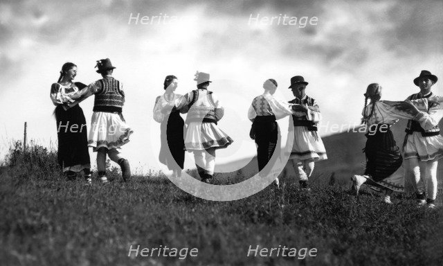 Couples in traditional dress dancing, Bistrita Valley, Moldavia, north-east Romania, c1920-c1945. Artist: Adolph Chevalier