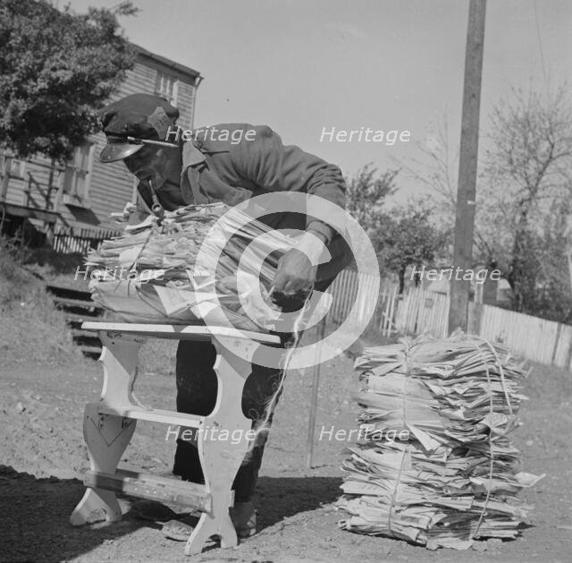 Mr. Venus Alsobrook, official salvage collector for the government wrapping..., Washington, DC, 1942 Creator: Gordon Parks.