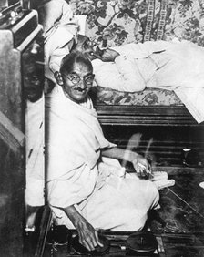 Mohondas Karamchand Gandhi (1869-1948), working at his spinning wheel. Artist: Unknown