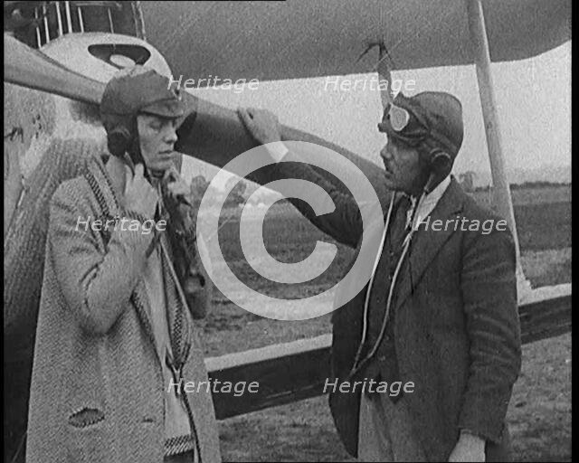 American Aviator Amelia Mary Earhart Wearing a Helmet in Front of an Airplane, 1920. Creator: British Pathe Ltd.