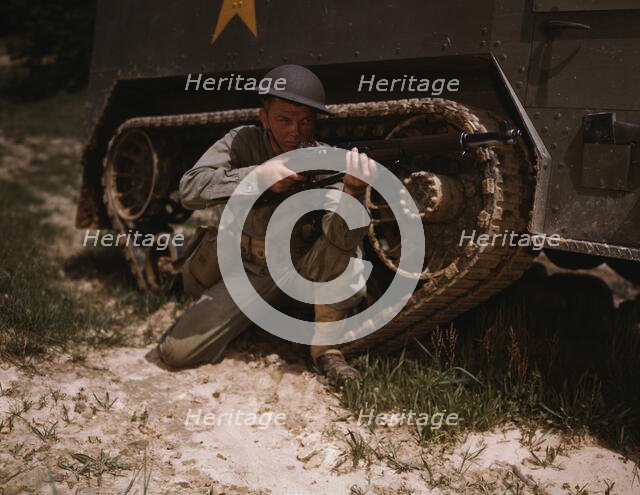 A young soldier of the armored forces holds and sights his Garand rifle..., Fort Knox, Ky, 1942. Creator: Alfred T Palmer.