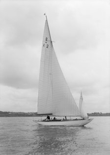 The 8 Metre Carron (K2) sailing upwind, 1934. Creator: Kirk & Sons of Cowes.