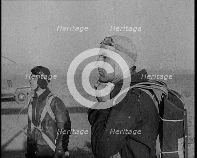 Pilot and Rear Gunner of Biplane Readying Themselves To Board Their Plane With One Adjusting...,1937 Creator: British Pathe Ltd.