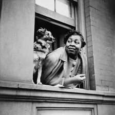 A woman and her dog in the Harlem section, New York, 1943. Creator: Gordon Parks.