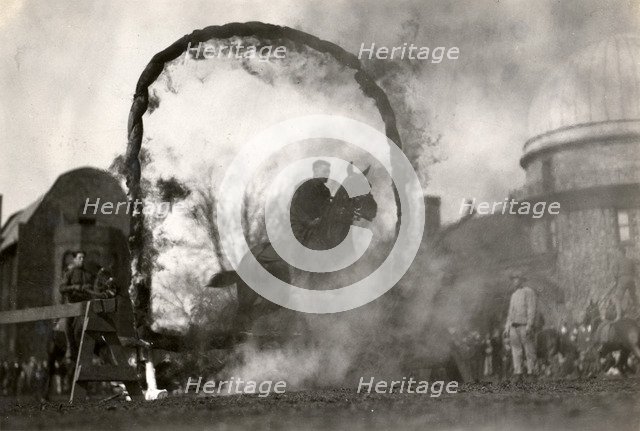 Soldier on horseback jumping through a flaming arch, Fort Sheridan, Illinois, USA, 1920. Artist: Unknown