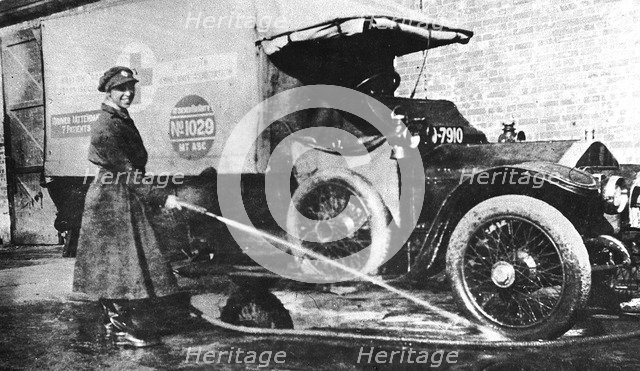 Volunteer English woman driver washing down her ambulance, Cambridge, World War I, 1915. Artist: Unknown