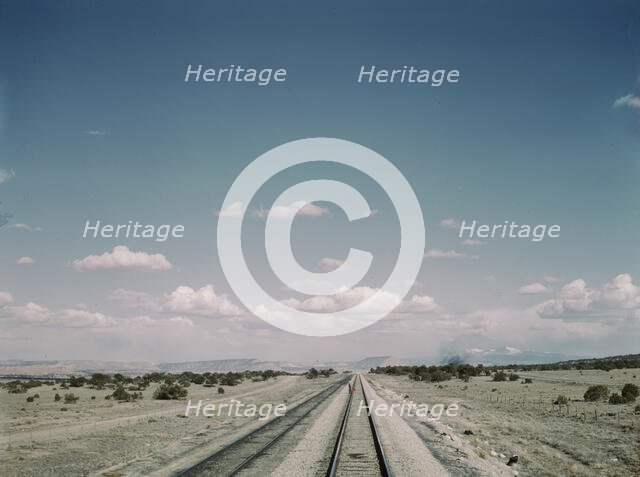 Flagman standing behind his train to flag oncoming trains at a small siding..., New Mexico, 1943. Creator: Jack Delano.
