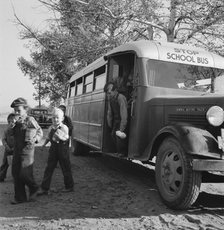 The children from Dead Ox Flat get off bus at school yard, Ontario, Oregon, 1939. Creator: Dorothea Lange.