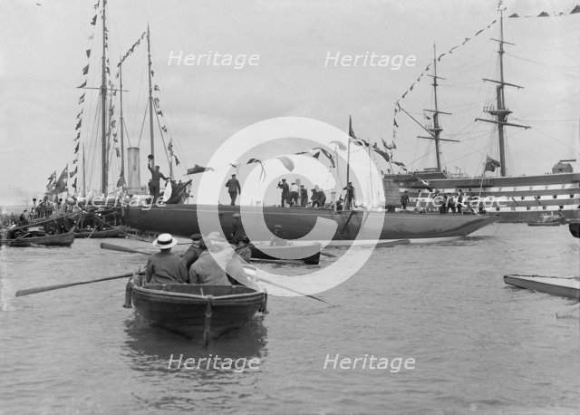 The launch of 'Shamrock IV' with H.M.S. Victory in the background, May 1914. Creator: Kirk & Sons of Cowes.