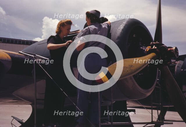Bowen, a riveter, and Olsen, her supervisor, in the Assembly...Air Base, Corpus Christi, Texas, 1942 Creator: Howard Hollem.