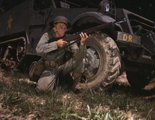 Infantryman with halftrack, a young soldier of the armed forces, holds..., Fort Knox, Ky., 1942. Creator: Alfred T Palmer.