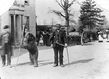 A dancing bear and owner performing outside an inn, Oxfordshire, c1900. Artist: Henry Taunt