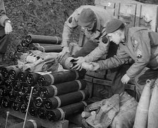 Allied Soldiers Loading Leaflets, Calling the Enemy to Surrender Into an Artillery Shell, 1943-1944. Creator: British Pathe Ltd.