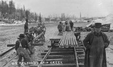 Laying first rails of new U.S. railroad at Ship Creek, between c1900 and c1930. Creator: Unknown.