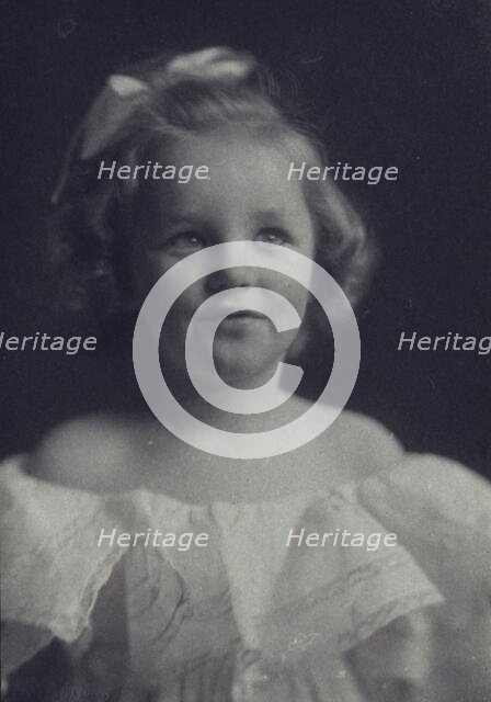 Young girl in a white off-the-shoulder dress with a ribbon in her hair , c1900. Creator: Anne K Pilsbury.