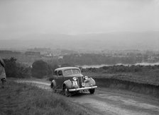 Ford V8 saloon competing in the South Wales Auto Club Welsh Rally, 1937 Artist: Bill Brunell.