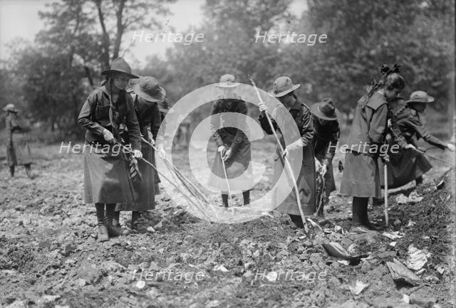 National Emergency War Gardens Com. - Girl Scouts Gardening at D.A.R., 1917. Creator: Harris & Ewing.