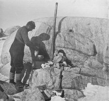 'Forde Cooking Seal-Fry on the Blubber Stove at Cape Roberts', c1911, (1913). Artist: Frank Debenham.