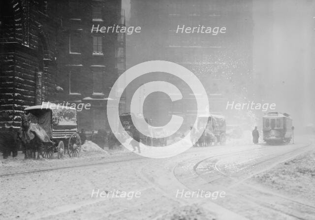 Horse-drawn wagons on snowy street, NY snow storm, 1910. Creator: Bain News Service.