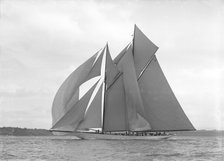 The 250 ton schooner 'Germania' sails downwind under spinnaker, 1911. Creator: Kirk & Sons of Cowes.