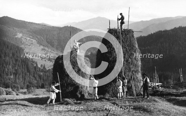 Building haystacks at harvest time, Bistrita Valley, Moldavia, north-east Romania, c1920-c1945. Artist: Adolph Chevalier