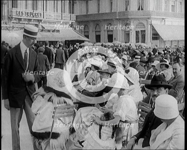 Scene from the Film 'The Compulsory Husband': Crowds of Holiday Makers Sitting at Out..., 1920s. Creator: British Pathe Ltd.