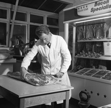 Butcher from Danish Bacon giving a demonstration, Kilnhurst, South Yorkshire, 1961.  Artist: Michael Walters