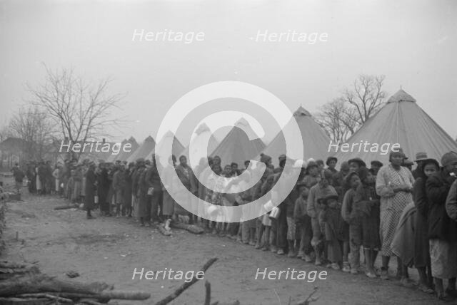 Possibly: Negroes in the lineup for food at mealtime in the camp..., Forrest City, Arkansas, 1937. Creator: Walker Evans.