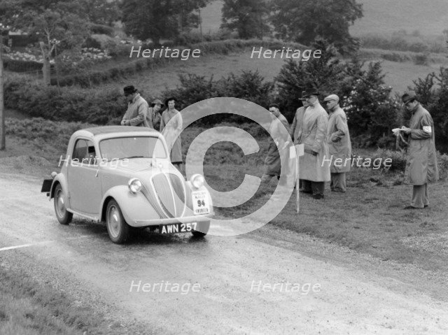 1937 Fiat 500 Coupe competing in the Welsh Rally. Artist: Unknown
