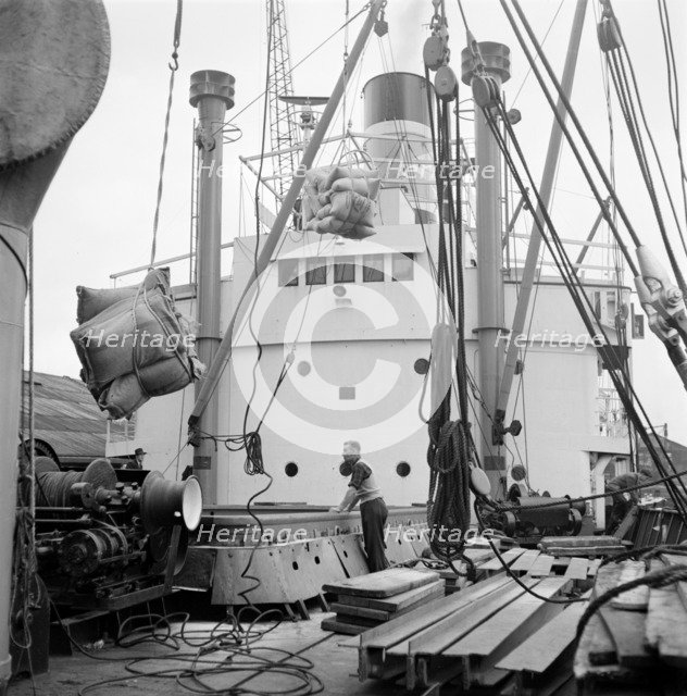 Loading a ship at the North Quay, West India Docks, London, c1945-c1965. Artist: SW Rawlings