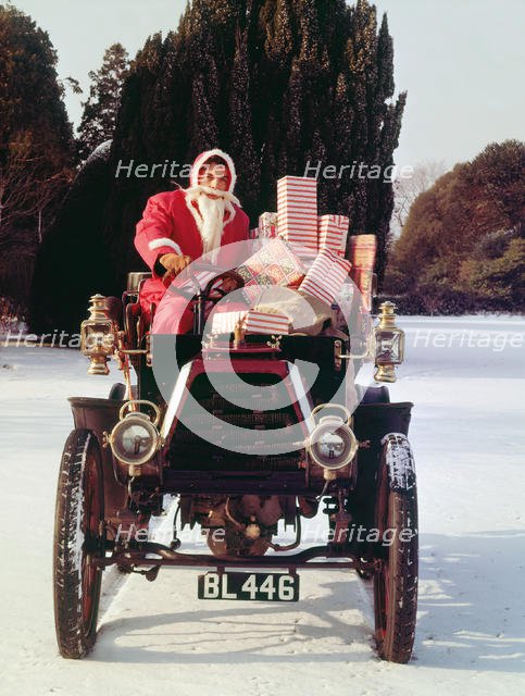 1901 Durkopp with Santa Claus delivering Christmas gifts. Creator: Unknown.