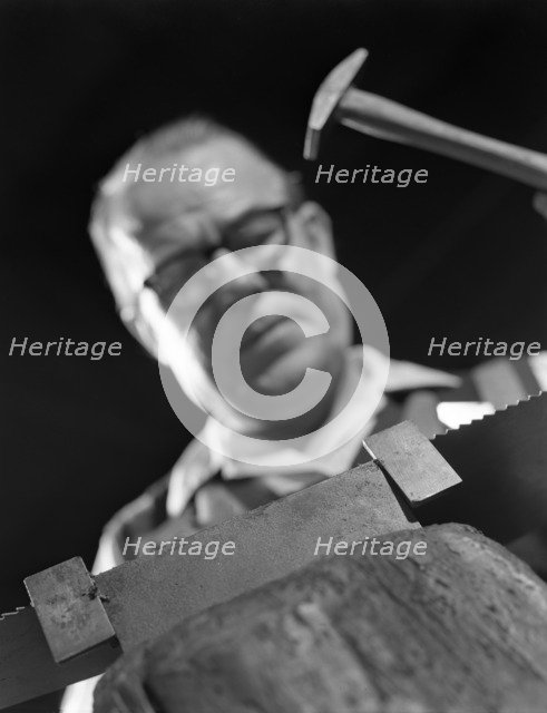 Setting the saw teeth on a hand saw blade, Sheffield, South Yorkshire, 1963. Artist: Michael Walters