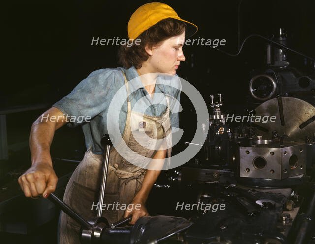 Lathe operator machining parts...Consolidated Aircraft Corporation plant, Fort Worth, TX, 1942. Creator: Howard Hollem.