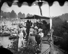 Men and women take tea on a college barge overlooking the Henley Royal Regatta, Oxfordshire, 1897. Creator: Henry Taunt.