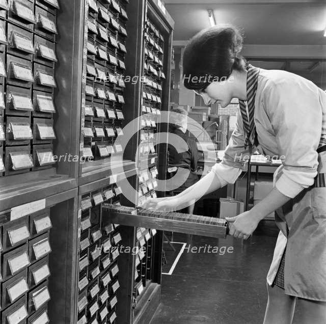 Woman looking through index cards, Medical Mailing Company, Ealing, London, 1960-1970. Artist: John Gay