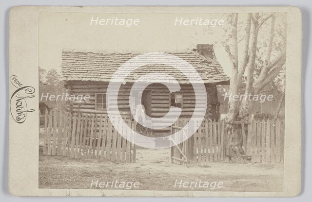 Albumen print of a woman and two children in front of a log house in Georgia, 1880s. Creator: H. S. Clark.