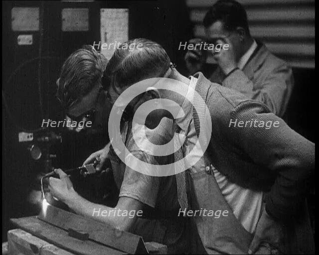 Man Inspecting an other Man Working With a Blowtorch, 1933. Creator: British Pathe Ltd.