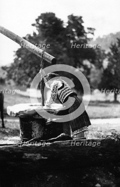 Woman getting water from a well, Bistrita Valley, Moldavia, north-east Romania, c1920-c1945. Artist: Adolph Chevalier