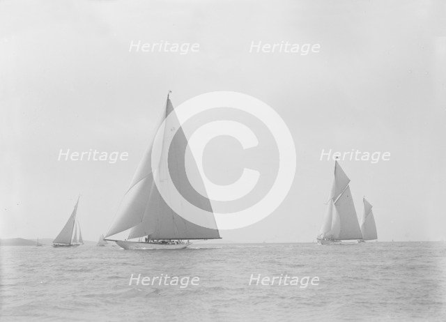 In the foreground the 23-metre cutter 'Astra' sailing on a reach. Creator: Kirk & Sons of Cowes.