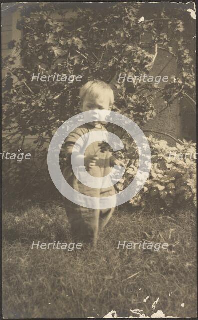 Portrait of a Child in Garden, 1907-1924. Creator: Louis Fleckenstein.